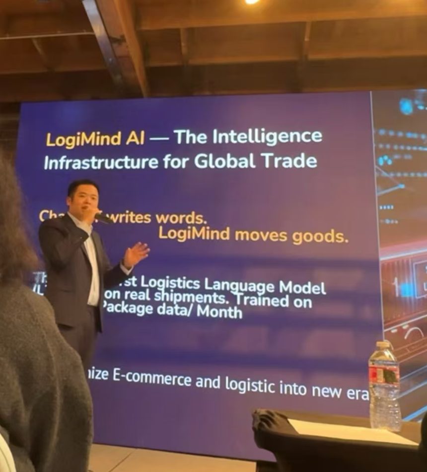 Andy Gor on stage with a microphone in front of a slide reading LogiMind AI